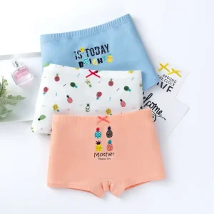 Three pairs of children's underwear in various colors with playful designs including pineapples and text.