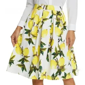 A White Skirt Featuring A Lemon Print With Green Leaves And Flowers.