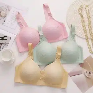 Four women's bras in pink, green, yellow, and beige displayed together on a flat surface.