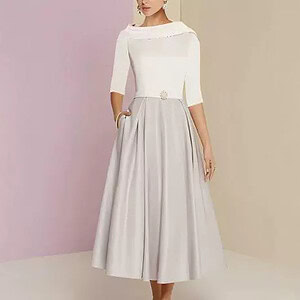 A two-tone midi dress featuring a white top and a gray skirt with pockets.