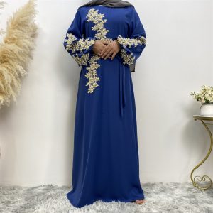 A blue dress featuring floral embroidery on the sleeves and front, worn by a model.