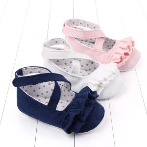 Pink, white, and navy baby girl shoes with ruffle details and polka dot insoles, perfect for infants and toddlers, combining comfort and adorable style for special occasions or daily wear.