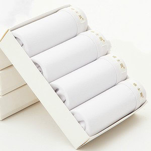 Four white cotton towels neatly arranged in a rectangular box.