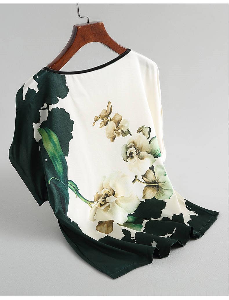 Floral Print Plus Size Silk Satin Bat Sleeve Shirt - Casual Elegance in Plus Sizes 3 Blouse Featuring A Floral Design With Green Accents Displayed On A Hanger.