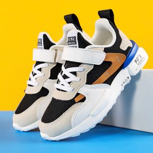 Stylish black and white sneakers with adjustable straps, breathable mesh upper, and modern design, perfect for active lifestyles and casual wear.