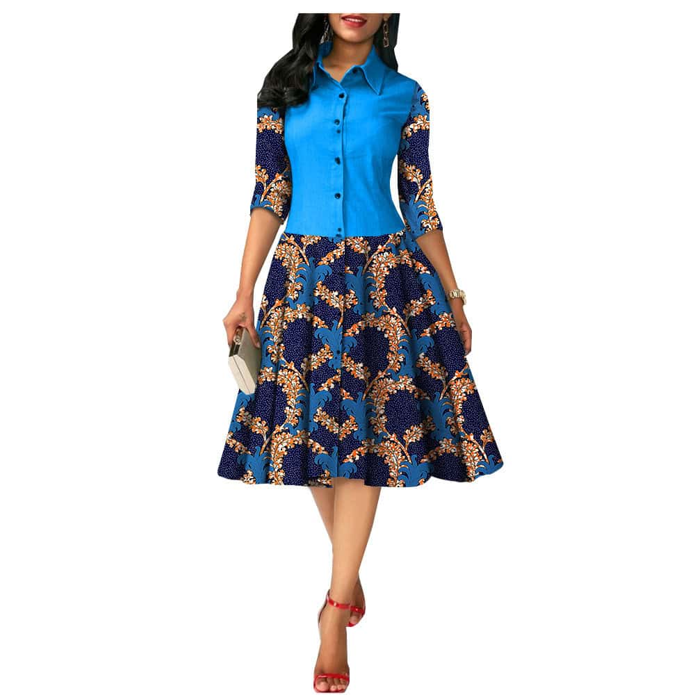 Chic African Print Summer Dress - Ideal for Sunny Days! - Style# 1825054 1 A Woman Wearing A Blue And Floral Print Dress With A Button-Up Top And A Flared Skirt.
