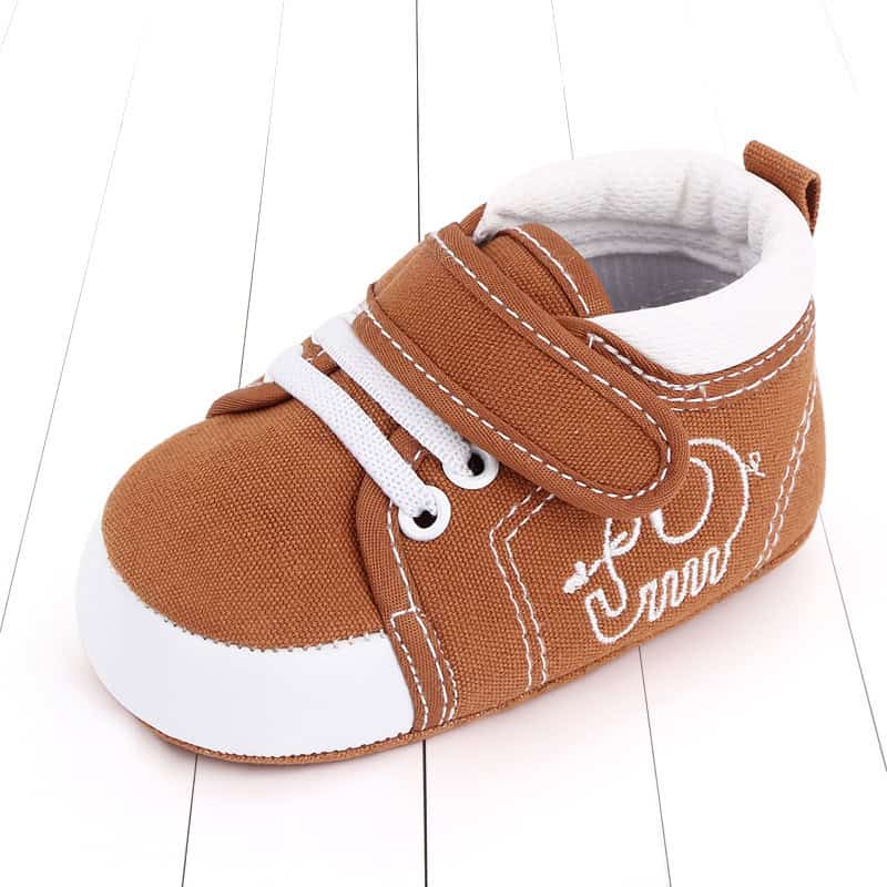 Cozy Baby Toddler Shoes: Ultimate Comfort & Safety for Your Little One 5 Soft Brown Toddler Baby Sneaker With White Laces And Velcro Strap, Designed For Comfort And Style, Perfect For Infants' Casual Wear.