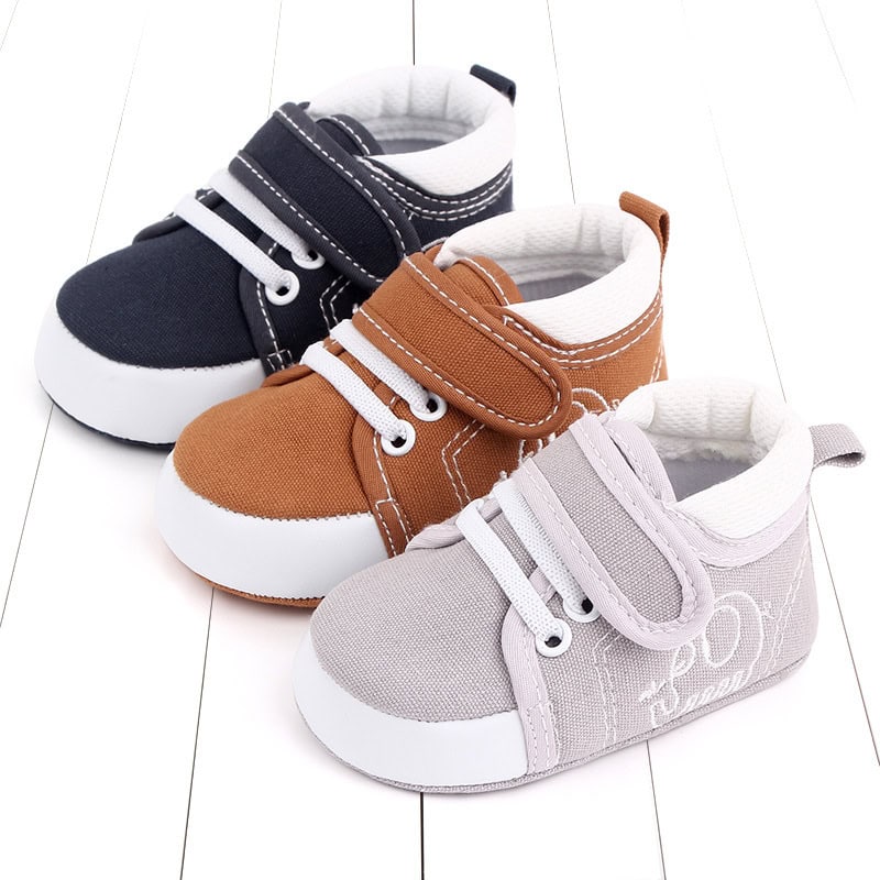 Cozy Baby Toddler Shoes: Ultimate Comfort & Safety for Your Little One 3 Soft Baby Sneakers In Navy Blue, Brown, And Light Gray With Velcro Straps And White Rubber Soles For Comfortable Toddler Footwear. Perfect For Early Walking And Everyday Wear.
