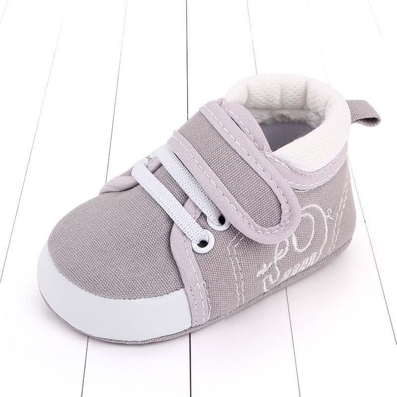 Cozy Baby Toddler Shoes: Ultimate Comfort & Safety for Your Little One 2 Comfortable Gray And White Baby Sneaker With Laces And Velcro Strap, Ideal For Newborns And Infants, Featuring Soft Fabric And Supportive Sole For Daily Wear.