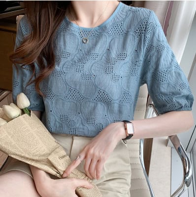 Fashion-forward: Women's Chic Embroidered Chiffon Shirt - Stylish & Breathable 7 Light Blue Top With A Textured Pattern And Puff Sleeves, Held By A Person With A Bouquet Of White Flowers.