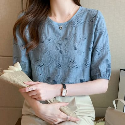 Fashion-forward: Women's Chic Embroidered Chiffon Shirt - Stylish & Breathable 3 Woman Wearing A Light Blue Eyelet Top With Short Sleeves, Holding A Bouquet Of Flowers.