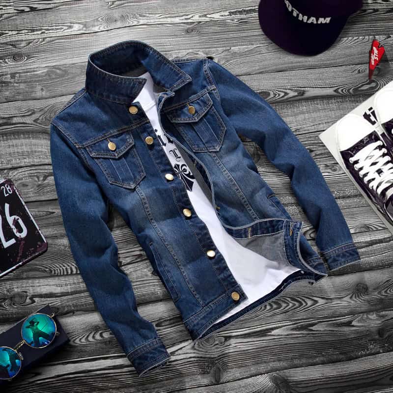 Classic Denim Jacket: Men's Stylish Casual Outerwear with Lapel Detail 1 Blue Denim Jacket With Button Closures And A Collar Laid Flat On A Wooden Surface.