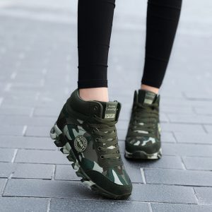 Sneakers with camouflage design on gray tiled pavement, sporty footwear for active lifestyle, stylish athletic shoes from Syndmart, outdoor running shoes for men and women, trendy sports sneakers for fitness and casual wear.