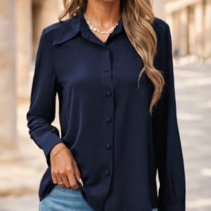 Woman wearing a navy blue button-up shirt with long sleeves and a collar.