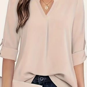 Light beige blouse with a V-neck and roll-up sleeves worn by a woman.