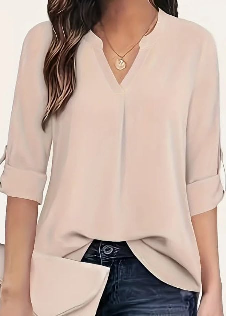 Chic V-Neck Blouse: Relaxed Fit, Long Sleeve Fashion for Women 1 Light Beige Blouse With A V-Neck And Roll-Up Sleeves Worn By A Woman.
