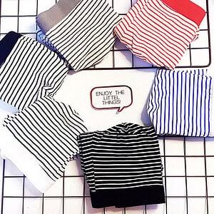 Collection of striped fabric swatches in various colors arranged on a grid background.