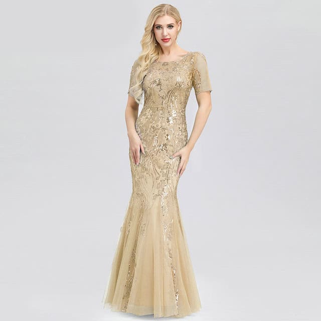 Elegant Mermaid Dress: Enchanting Style for Graceful Occasions 4 A Woman Wearing A Beaded Evening Gown With A Mermaid Silhouette In A Neutral Color.