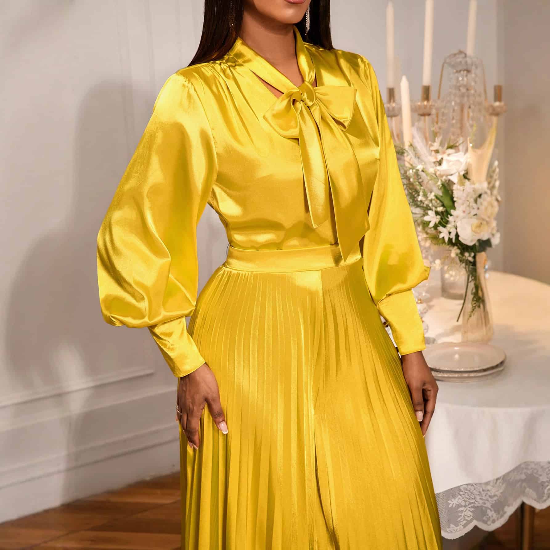 Chic V-neck Top & Wide Leg Trousers Set with Bow Detail - Elegant Fashion Combo 2 Woman Wearing A Yellow Satin Dress With A Bow Tie At The Collar And Pleated Skirt.