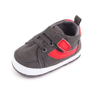 Gray and red baby sneakers with a Velcro strap and lace design.