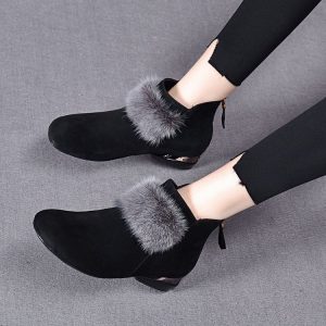 Elegant black ankle boots with faux fur trim, perfect for winter fashion and stylish outfits. Ideal for women seeking comfortable yet trendy footwear for cold weather.