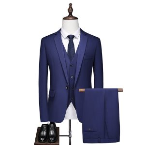 Elegant men's blue suit set with matching trousers, white shirt, navy tie, black dress shoes, ideal for business or formal occasions, showcased on a mannequin.