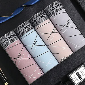 Four cylindrical packages of men's socks in pink, blue, and gray colors with geometric patterns.