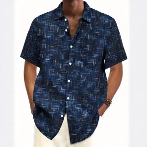 Patterned men's short-sleeve button-up shirt with geometric blue and black design, casual style, suitable for summer or beachwear.