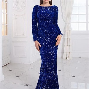 A woman wearing a long blue sequin evening dress with long sleeves and a fitted silhouette.