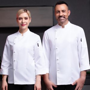 Two individuals wearing white chef coats, one male and one female, standing side by side.