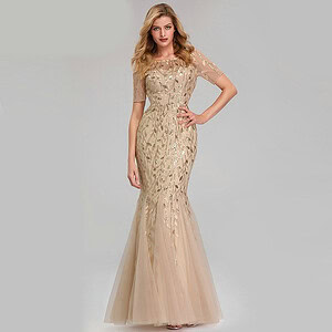 Beige evening gown featuring intricate embroidery and a mermaid silhouette.