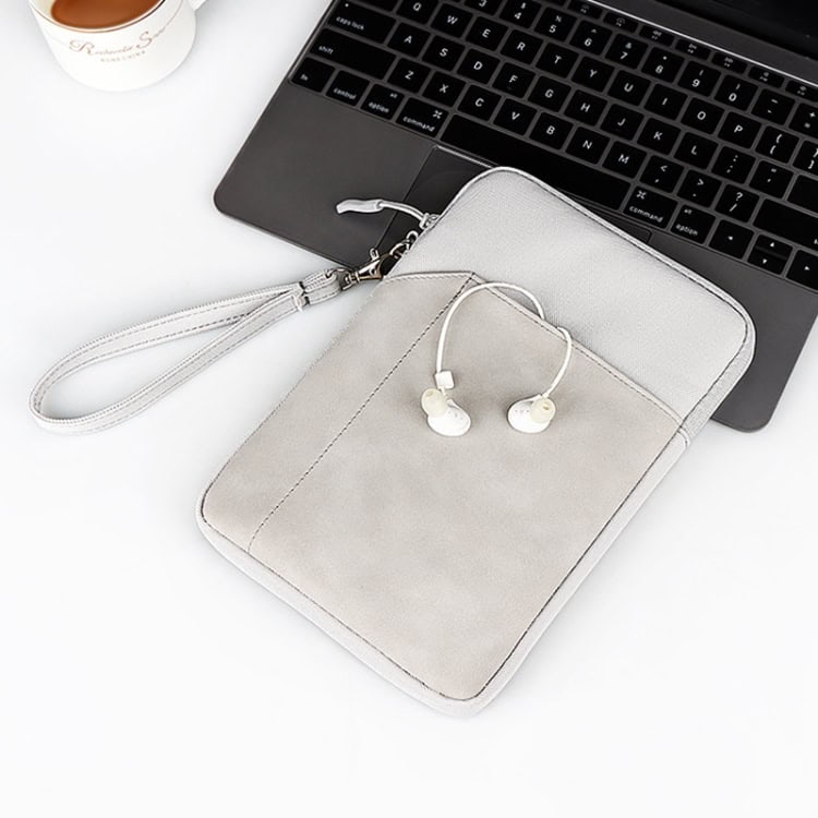 ND00S Felt Sleeve Protective Case: Inner Carry Bag for Ultimate Protection 9 Wireless Earphones With A White Case On A Laptop Keyboard, Close-Up Of Portable Tech Accessories For Digital Work Or Travel.