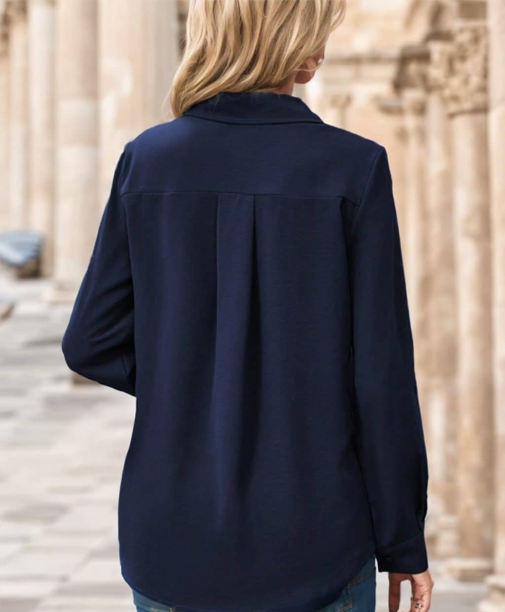 Chic Solid Women's Shirts: Versatile style for the modern woman - a wardrobe essential. 3 Back View Of A Woman Wearing A Navy Blue Long-Sleeve Shirt With A Collar.