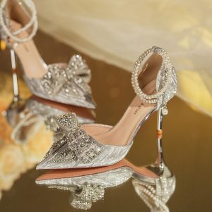 Elegant silver high heel shoes adorned with pearls and sparkling embellishments, perfect for bridal or special occasions, showcased by Syndmart.