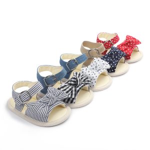 Comfortable children's sandals featuring colorful polka dot and striped bows with adjustable straps and soft soles for summer wear.