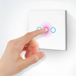 Hand pressing a touch control light switch with circular indicators on a white panel.