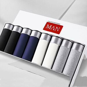 Eight pairs of men's socks in a box, featuring black, navy, white, and gray colors.