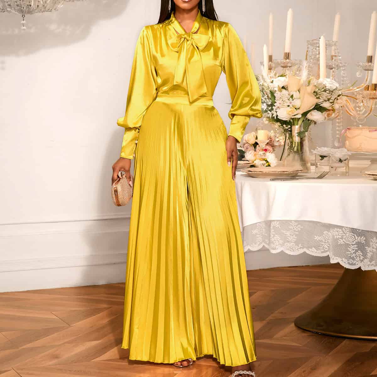 Chic V-neck Top & Wide Leg Trousers Set with Bow Detail - Elegant Fashion Combo 5 Woman Wearing A Yellow Satin Pleated Jumpsuit With A Bow Tie At The Collar.