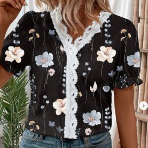 Black blouse with floral patterns and lace trim on the front.