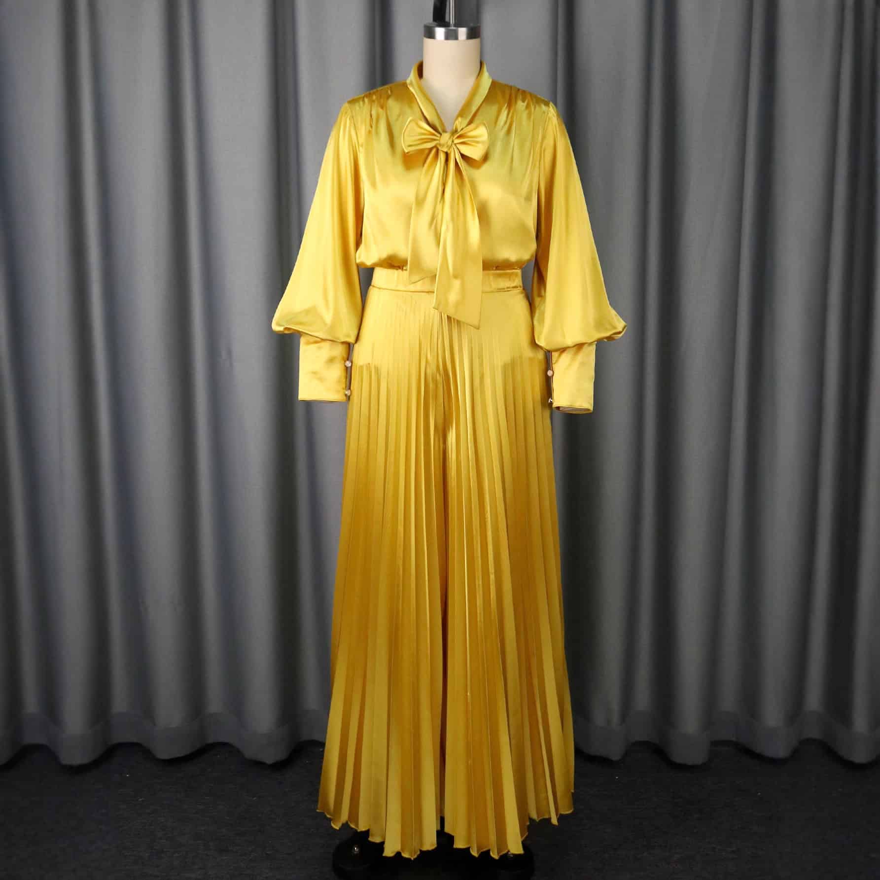 Chic V-neck Top & Wide Leg Trousers Set with Bow Detail - Elegant Fashion Combo 4 Yellow Two-Piece Outfit Featuring A Pleated Skirt And A Blouse With A Bow Tie On A Mannequin.