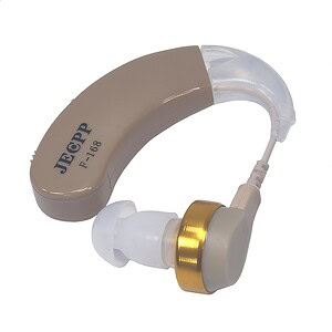 Hearing aid device with beige ear hook and gold accents for enhanced sound clarity and comfort.