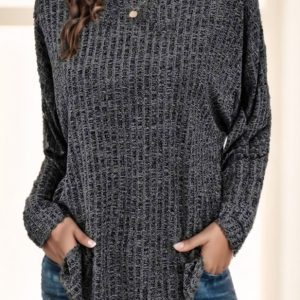 Woman wearing a gray ribbed long sleeve top with a round neckline and side pockets.