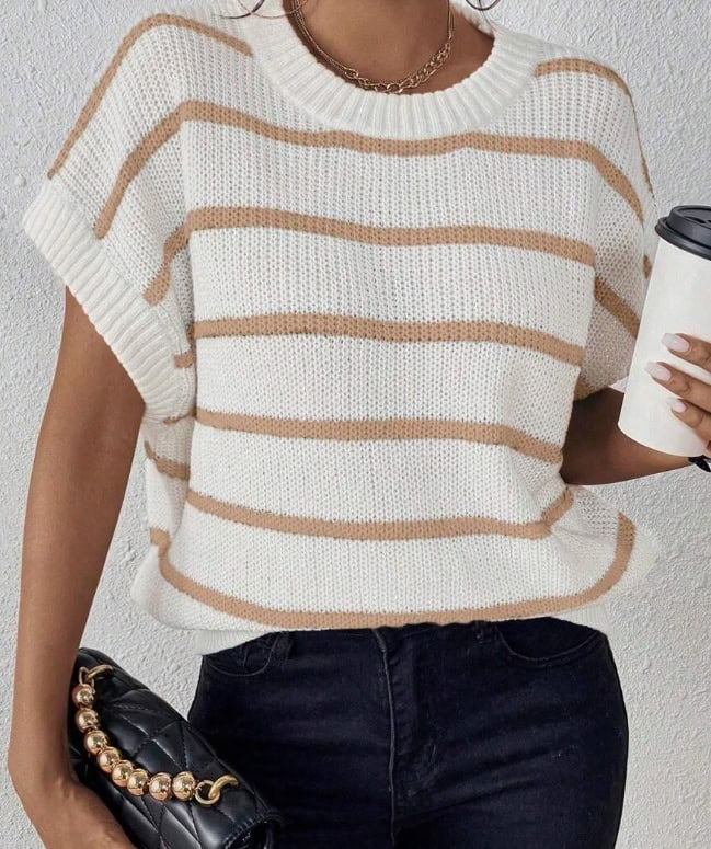 Chic Striped Batwing Knit Top - Effortless Style Statement 3 A Woman Wearing A White Striped Knit Sweater With Short Sleeves, Holding A Coffee Cup And A Black Handbag.
