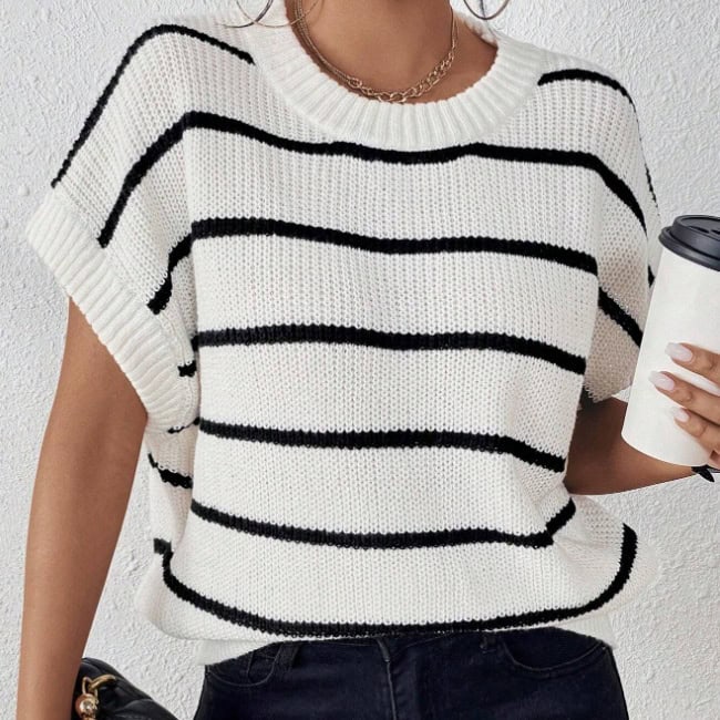 Chic Striped Batwing Knit Top - Effortless Style Statement 1 A White Knit Sweater With Black Horizontal Stripes Worn By A Person Holding A Coffee Cup.