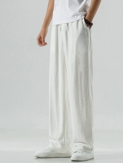 Effortless Elegance: White Casual Tunic Suit for Any Occasion 3 A Person Wearing White Loose-Fitting Pants With A White T-Shirt And White Shoes.