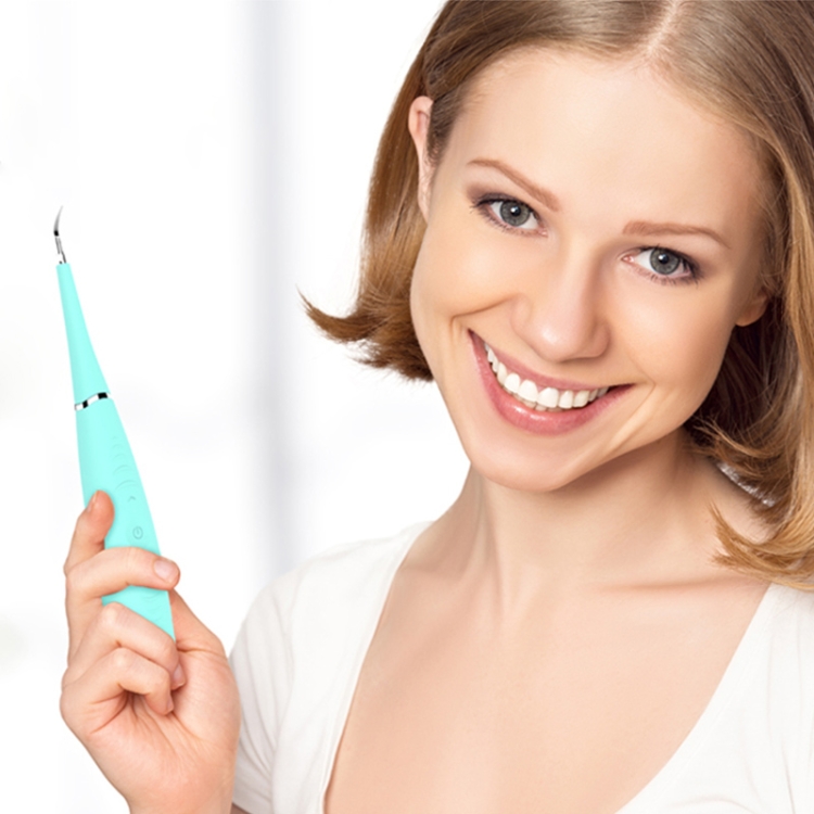 LSHOW YJK015A Waterproof Electric Teeth Polisher - USB Charging, High-frequency Vibration 7 Smiling Woman Holding A Turquoise Dental Cleaning Tool With A Curved Tip.