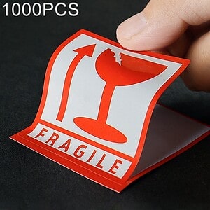 Fragile sticker for product packaging, 100pcs, red and white design, indicating delicate contents, used for shipping and handling, ideal for couriers and online sellers to ensure safe delivery of fragile items.