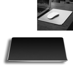 Wireless white mouse on a silver laptop trackpad.
