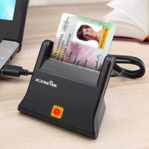 High-speed ID card scanner placed on a wooden desk connected to a laptop for efficient card processing and digital identification.