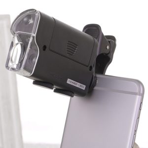 Black clip-on flashlight attached to the back of a smartphone for enhanced lighting.